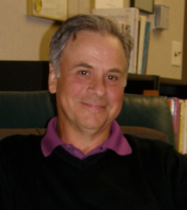 Smiling man sitting in an office.